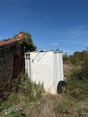a white refrigerator sitting in the middle of a field