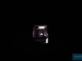 a purple diamond in the dark with a black background