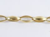 a close up of a gold chain on a white surface