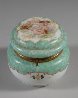 a small box with a painting on it on a table