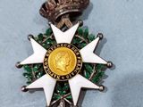 a silver and gold medal with a crown on top of it