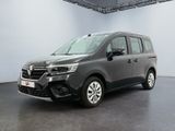 La camionnette grise est garée dans une grande pièce.