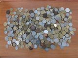 a pile of coins sitting on a wooden table