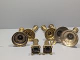 four antique brass door handles and knobs on a white surface