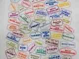 a white t - shirt with a bunch of stamps on it