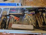 a drawer full of kitchen utensils and other items