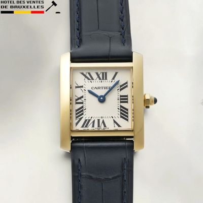 an image of a gold wrist watch with roman numerals on the face