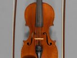 a violin that is sitting on the wall next to a bow