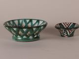 two small bowls sitting next to each other on a table