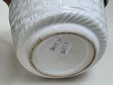 a close up of a vase with a tag on it