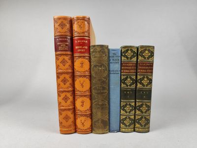 trois livres sont alignés sur une surface blanche