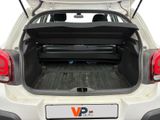 the back end of a white car with the trunk open