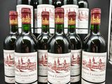six bouteilles de vin rouge sont alignées sur une table