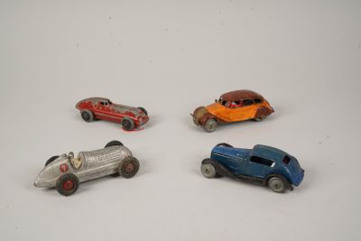 several toy cars are lined up in a row on a white surface