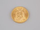 an image of a gold coin sitting on top of a white surface