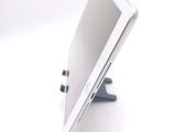 a tablet computer sitting on a stand on a white surface