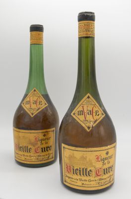 two bottles of beer sitting next to each other on a white surface