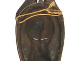 an image of a wooden mask with a rope around it ' s neck