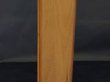 a wooden cabinet with a door open on a black surface