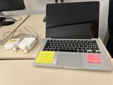 a laptop computer sitting on a desk next to a computer monitor