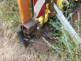 a close up of a machine that is sitting in the grass