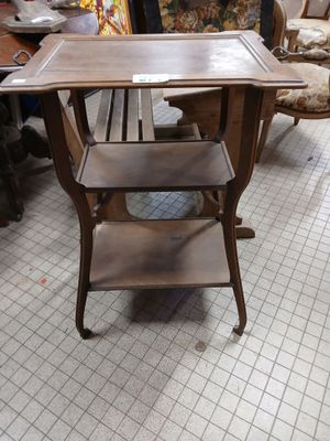 a wooden table with a shelf on it in a room