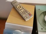 two remote controls sitting on top of boxes on a table