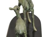 a statue of a goat and a baby goat on a black base