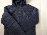 the jacket is blue and has a hood that is attached to it