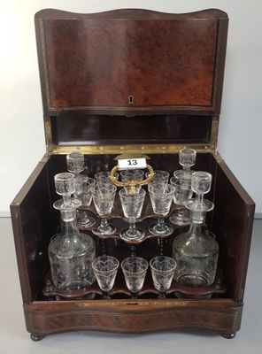 a wooden box with a bunch of glasses inside of it