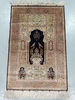 an oriental rug hanging on a wall in a room