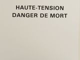 white paper with black writing on it that says haute tension danger de mort