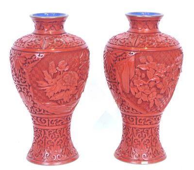 two vases that are sitting on a white surface