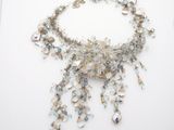 an image of a necklace made out of glass beads on a white surface
