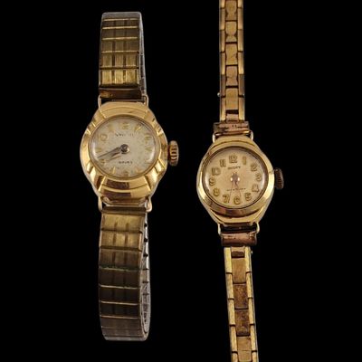 pair of ladies ' s wrist watches on display against a black background