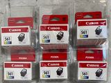 six canon ink cartridges in plastic bags on a table