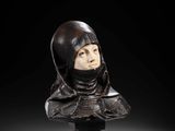 a carved bust of a woman wearing a helmet and scarf