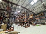 a large warehouse filled with lots of shelves and pallets