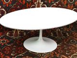 a white table sitting on top of a red couch