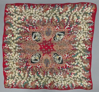 a red square scarf with a floral design on it