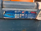 a box with a sticker on it sitting on a trash can
