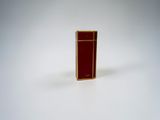 a small red object on a white surface