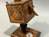 a small wooden box with a clock on top of it