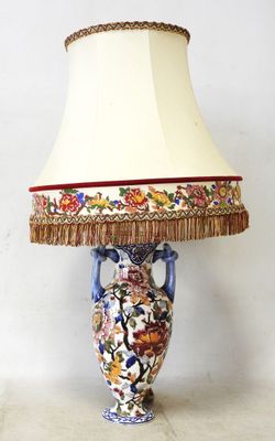 a lamp that is sitting on a table with a lamp shade on it