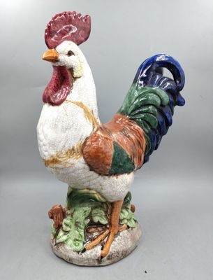 a figurine of a rooster on a pedestal