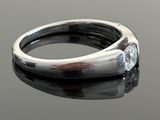 an image of a diamond ring on a black surface