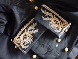 an image of a black jacket with gold trimmings