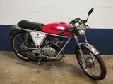 a red and black motorcycle parked in a garage