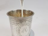 a silver cup with a spoon sticking out of it