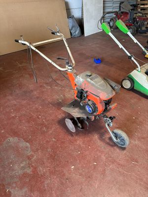 two lawn mowers that are sitting in a garage
